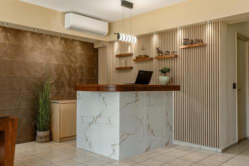 a lobby with a counter with a laptop on it at Varvara's Diamond - Adults Only in Platanes
