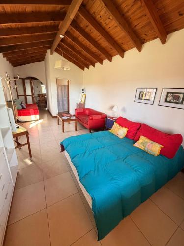 a bedroom with a large blue bed in a room at La Candelaria - Casas de Campo - in Sierra de la Ventana