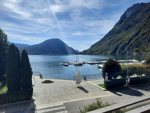 a view of a lake with boats in the water at La Rosa di Ilde in Porlezza