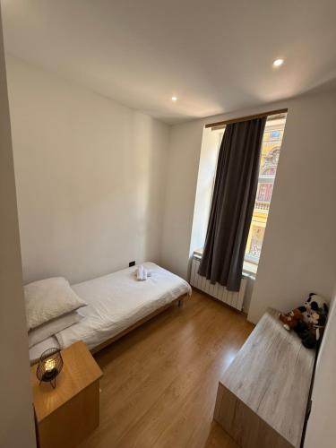 a small bedroom with a bed and a window at Rooms Gollner in Zagreb