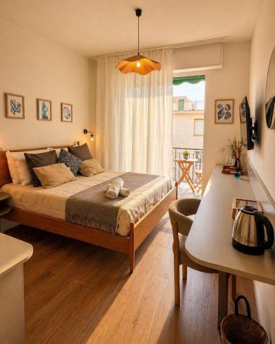 a bedroom with a large bed and a table at Riva Viola in Alassio