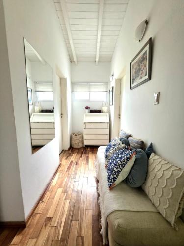 a living room with a couch and a bedroom at Los robles suite in San Pedro