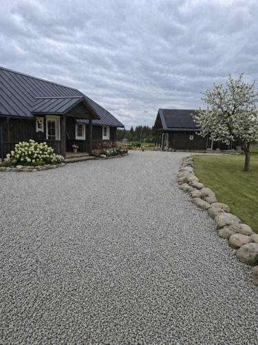 a gravel driveway in front of a house at Kregžlės kaimas in Skirlėnai
