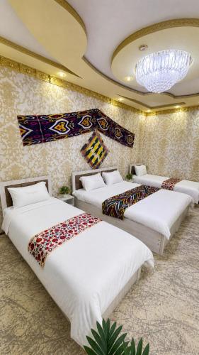 a row of beds in a room at Sole Family Guesthouse in Samarkand