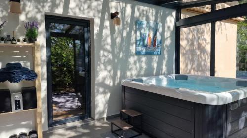 a bathroom with a large tub in a room at Avalavanda Cherry Hill in Vlasi