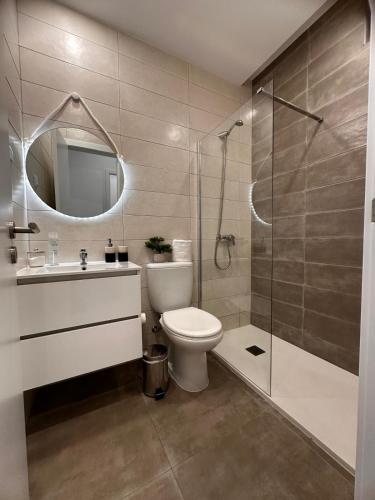 a bathroom with a toilet and a sink and a shower at Casa Maria Olímpia in Nazaré