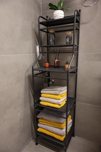 a black towel rack with towels on it in a bathroom at Luxury Villa Yvonni in Poros