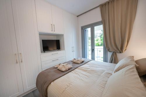 a bedroom with a bed with two towels on it at Luxury Villa Yvonni in Poros