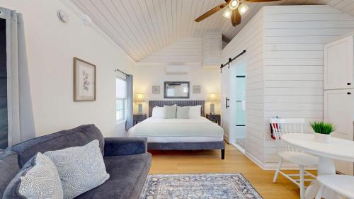 a white bedroom with a bed and a couch at Coastal Estate in Cape May