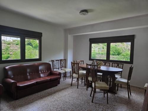 a living room with a couch and a table and chairs at Casa Bajo Castillo in Montán
