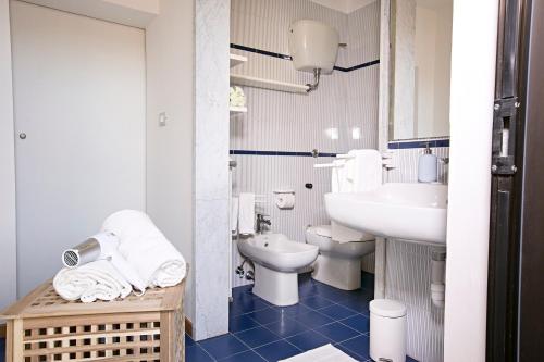 a white bathroom with a sink and a toilet at Dido in Roseto degli Abruzzi