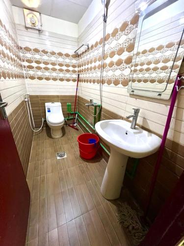 a bathroom with a sink and a toilet at Home Line in Doha