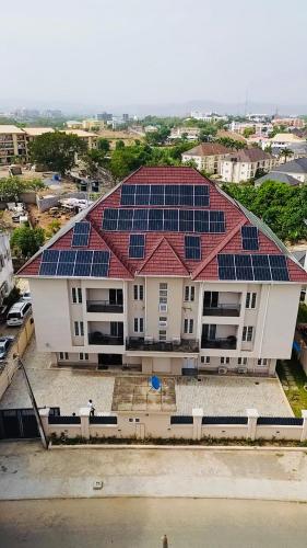 a building with solar panels on the roof at House 10 Apartments in Abuja