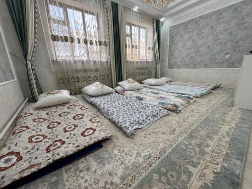a group of four beds in a room at Starpath Homestay in At-Bashy