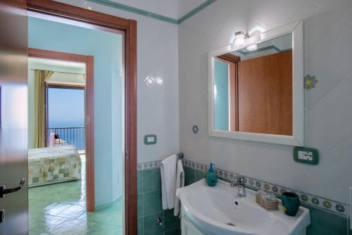 a bathroom with a sink and a mirror at Calipso Residence in Furore