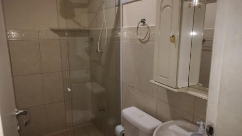 a bathroom with a shower and a toilet and a sink at Ap cobertura próx Vila Militar, Afonsos e CEFAP in Rio de Janeiro