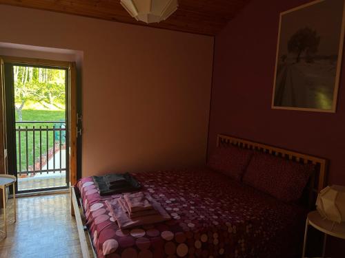 a bedroom with a bed in a room with a window at Casa Tritapepe in Torricella Peligna
