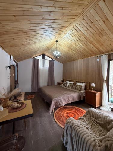 a bedroom with a bed and a couch in a room at Sant House Dilijan in Dilijan
