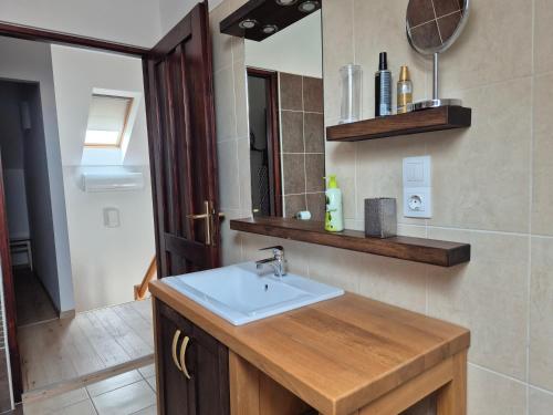 a bathroom with a sink and a mirror at Fay-home in Odorheiu Secuiesc