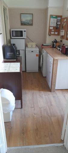 a kitchen with a counter and appliances in a room at Fern Cottage in Scalby