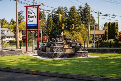 a fountain in the middle of a street with a sign at The Tide's Out in Parksville