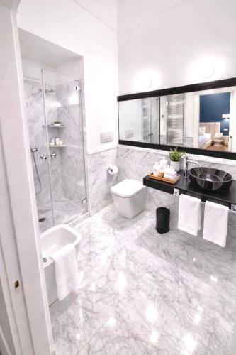 a bathroom with a shower and a toilet and a sink at Sorrento Downtown in Sorrento