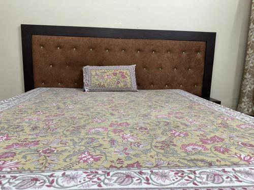 a bed with a blanket and a pillow on it at Dj's home stay in Jodhpur