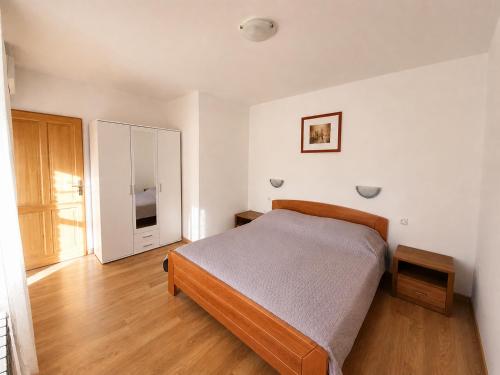a bedroom with a bed and a dresser in it at Apartments Renato Mužić Cres in Cres