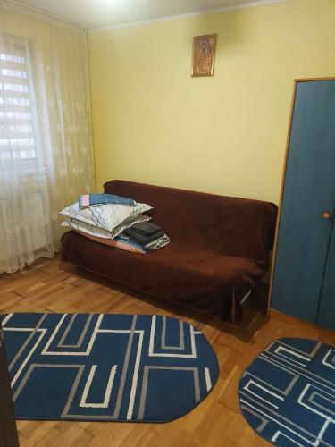 a living room with a couch and a blue rug at Emilia's Dreamhouse in Gura Humorului
