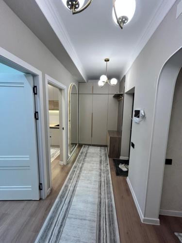 a hallway with white walls and a ceiling at Lola in Osh