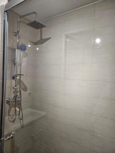 a bathroom with a shower with a glass door at Apartament Wiejska Sielanka in Ryn