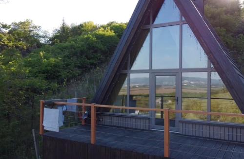 a view from the deck of a house with a large window at A frame Miška in Nána