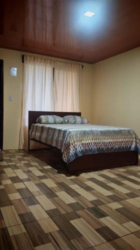 a bedroom with a bed in a room at Cabañas Montañas del Tenorio in Rio Celeste
