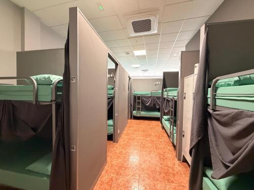 a corridor of a train with bunk beds at Albergue Argemira - Grupo Arcanos in Caldas de Reis