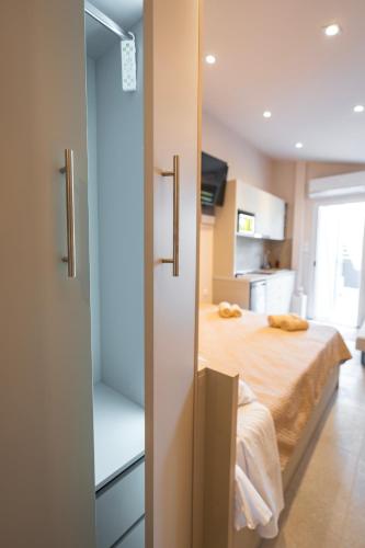 a bedroom with a bed and a room with a window at Mediterranean Studio Halkidiki in Nea Kallikrateia