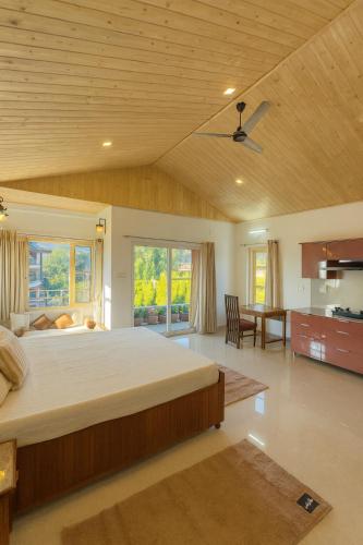 a large bedroom with a large bed and a kitchen at Sixtofifty Stays in Dharmsāla