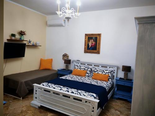 a small bedroom with a bed and a chandelier at Le stanze di Anna in Capaci