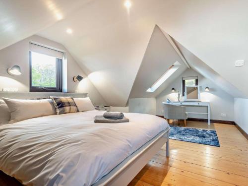 a bedroom with a large bed and a desk at 1 Bed in Isle Of Arran oc-ca272 in Pirnmill