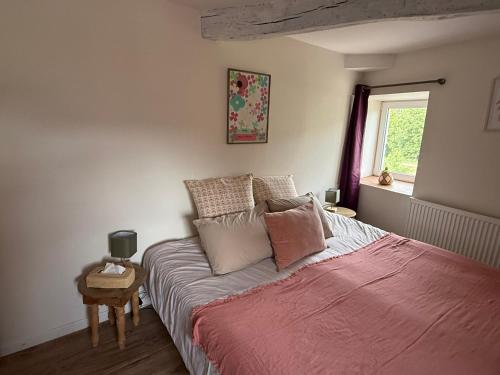 a bedroom with a bed with a red blanket at L eau douce in Ménétréol-sous-Sancerre