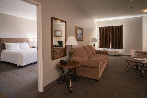 a hotel room with a bed and a couch at Branson Towers Hotel in Branson