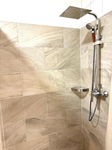 a bathroom with a shower with a glass door at FAVORIT-ROOMS , direkt Metro connection U1 to Centralstation-Airport and City-Center in Vienna