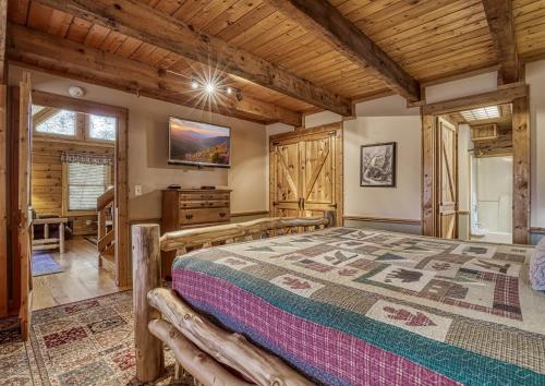 a bedroom with a large bed and wooden ceilings at Mountain Memories Is A Perfect Mountain Getaway For A Family Or Couples Retreat! in Sevierville