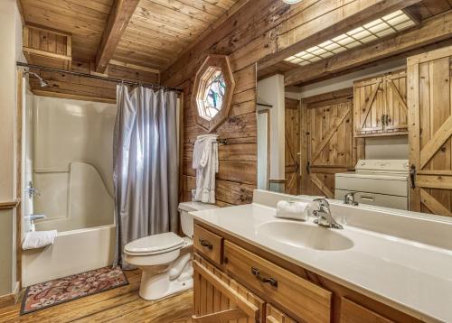 a bathroom with a sink and a toilet and a tub at Mountain Memories Is A Perfect Mountain Getaway For A Family Or Couples Retreat! in Sevierville