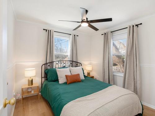 a bedroom with a bed and a ceiling fan at Charming 3BD 2BR Dog Friendly in Overland Park