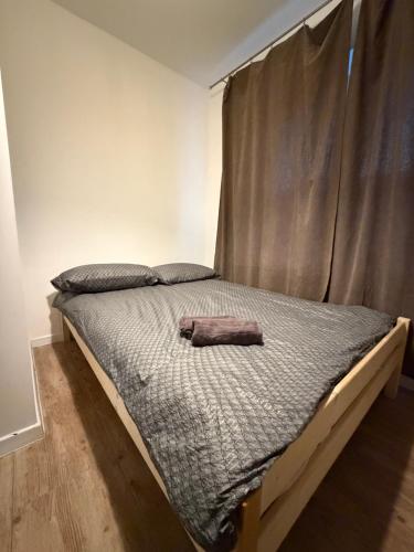 a bedroom with a bed with a towel on it at Host-X Pokoje Ciche Centrum Mała Sienkiewicza -fv in Kielce