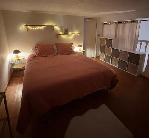a bedroom with a large bed and two lamps at Villa la serella in Brando
