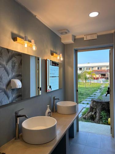 two sinks in a bathroom with a large window at Residence Toscano in Palmi
