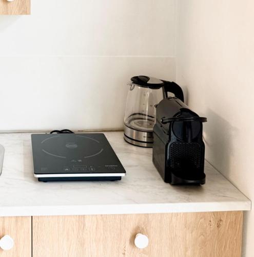 a laptop computer sitting on a counter with a blender at Casa Buda 2BR Apartment-Lakes Malpensa MXP 24h Check-in Parking in Sesto Calende