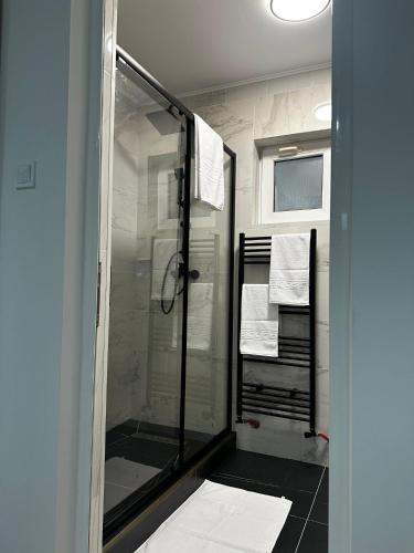 a bathroom with a glass shower with towels on it at Robert Urban Class in Gura Humorului