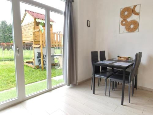 a dining room with a table and chairs next to a sliding glass door at Casa Buda 2BR Apartment-Lakes Malpensa MXP 24h Check-in Parking in Sesto Calende